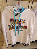 White hoodie with colorful 'Magic Kingdom' text on a hanger.