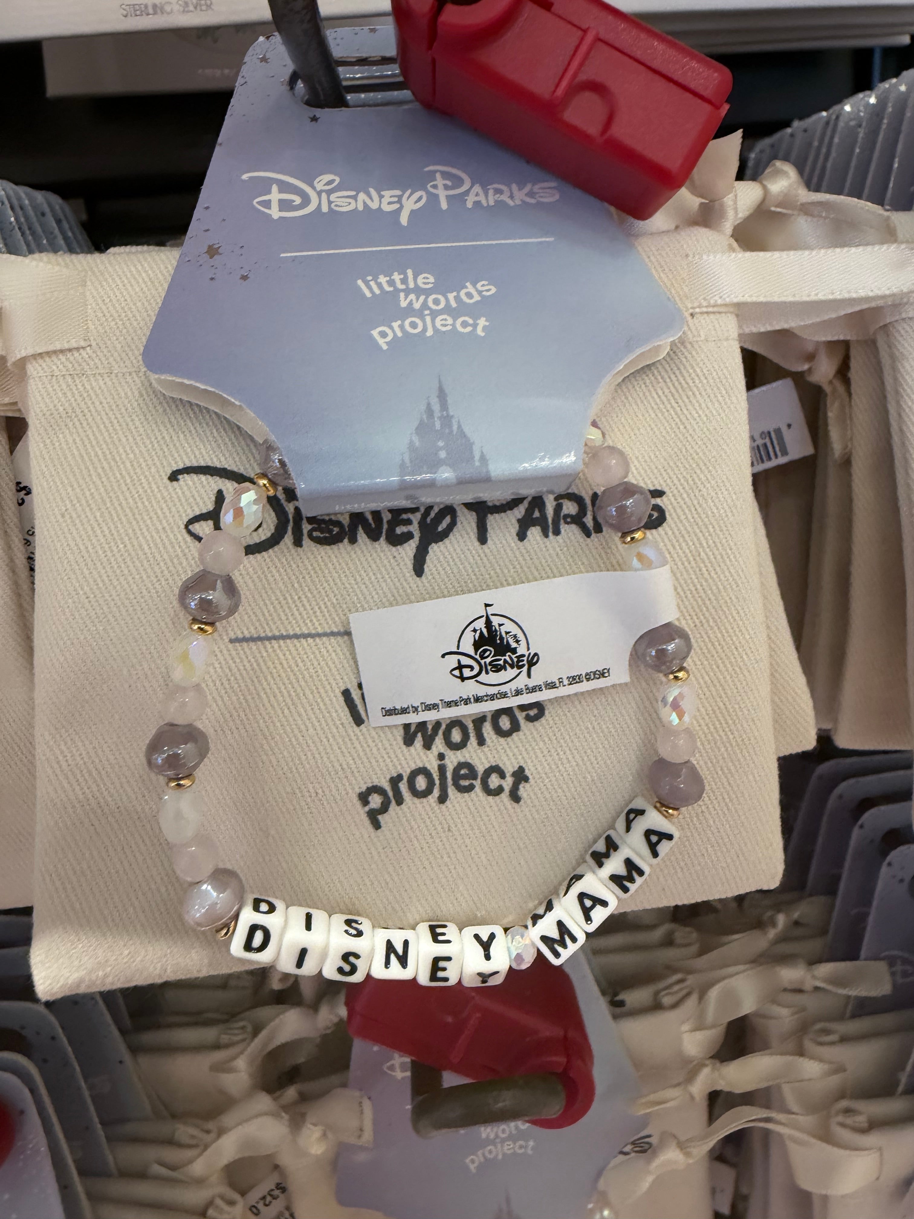 Bracelet with 'Disney' branding on a display with other merchandise.